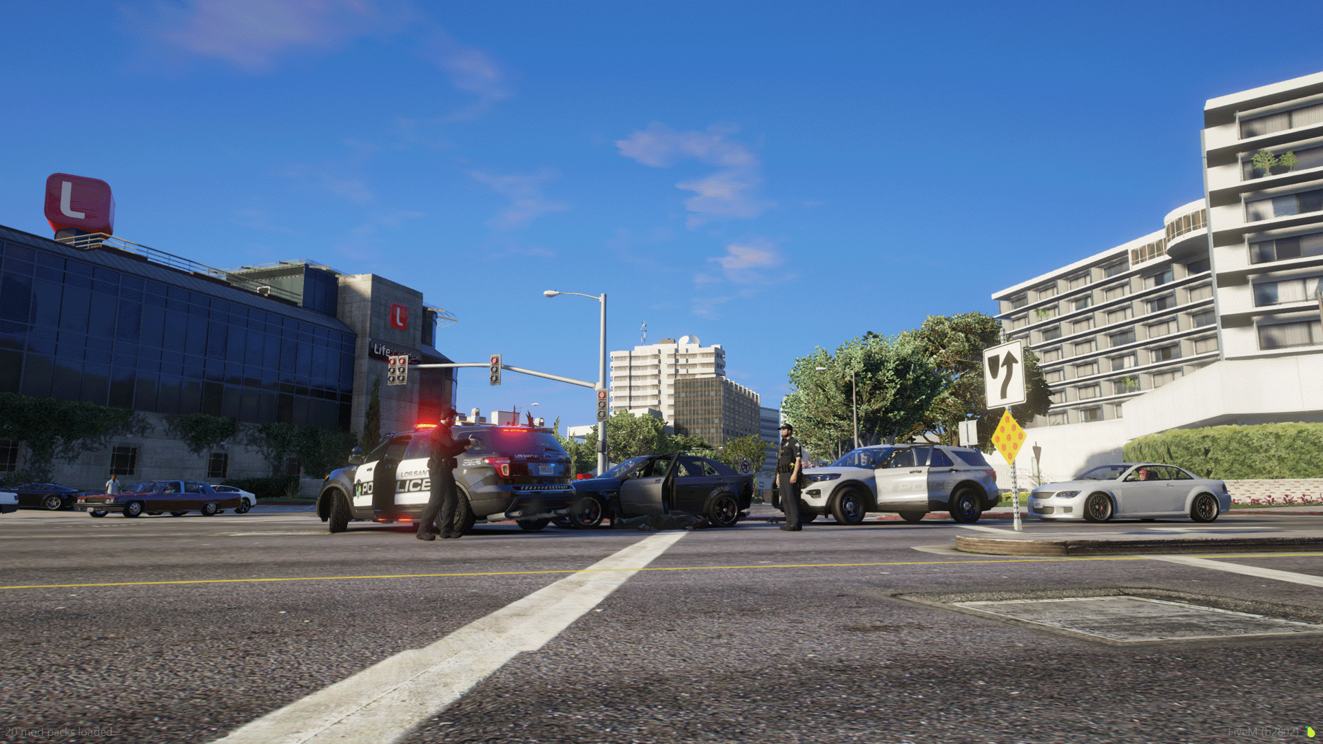 Officers investigate a stolen vehicle involved in a collision at the Life Invader building.