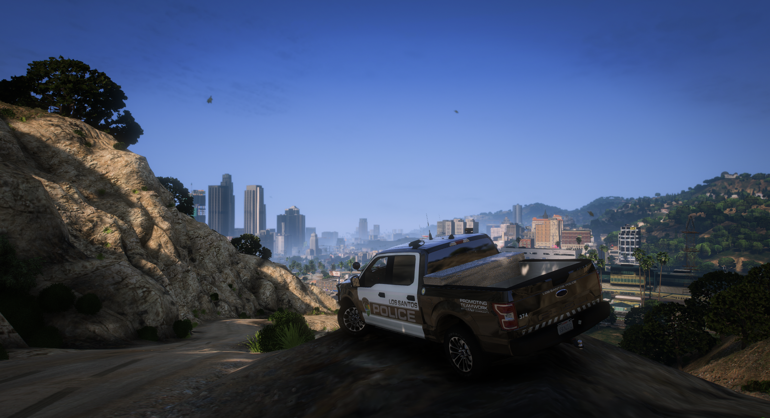 Cinematic view of an LSPD truck on the upper hills overlooking the city.