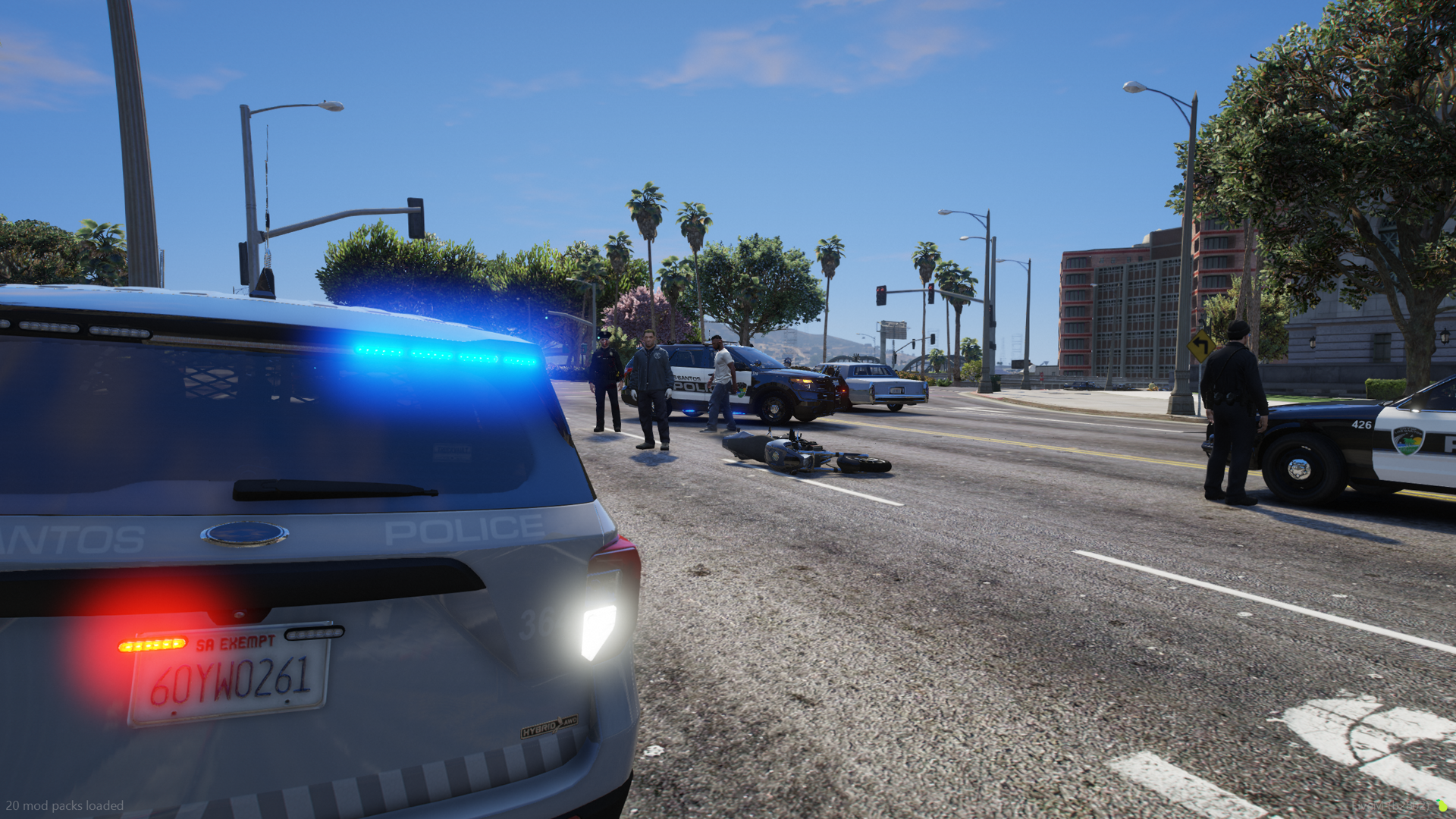 Officers secure the scene after a motorcycle pursuit ends with a stolen bike down on the road.